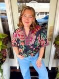 A botanical print in vibrant shades of pink, green, coral and cream.