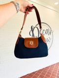 small saddle crossbody in navy and brown with chain strap