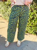 Green leopard denim pants with a barrel leg fit to them