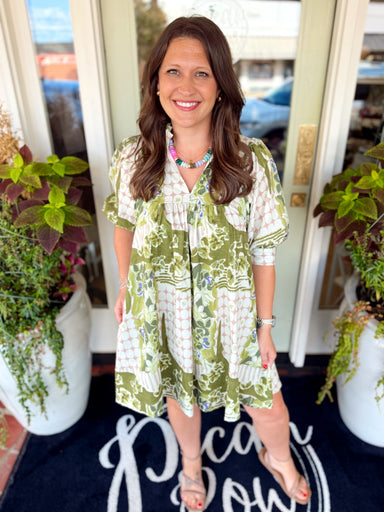  This babydoll dress features a unique mixed botanical and geometric print in olive green, cream, blush and touches of lavender. 