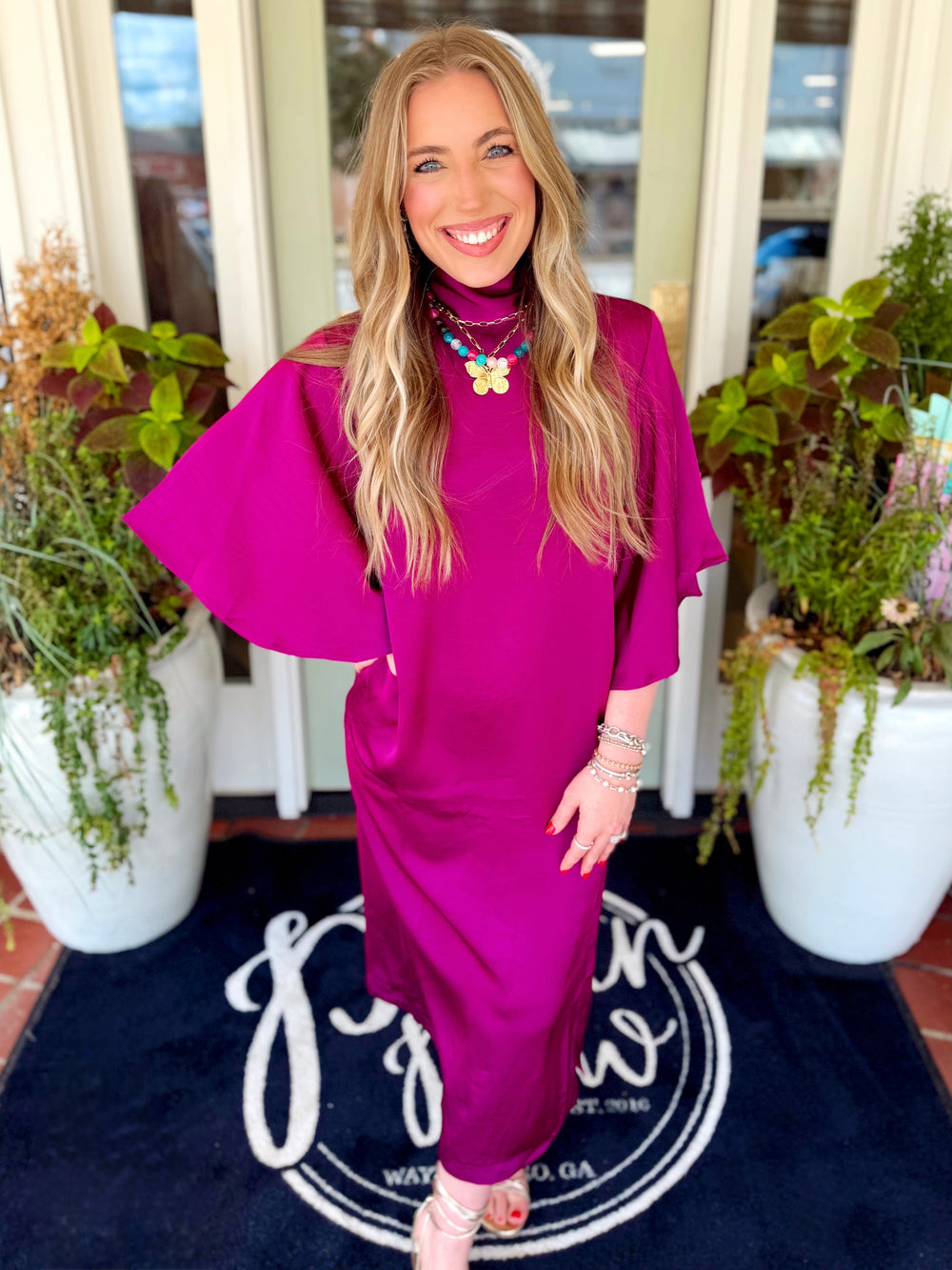 A straight satin plum drop sleeve dress  with a tie detail on the back