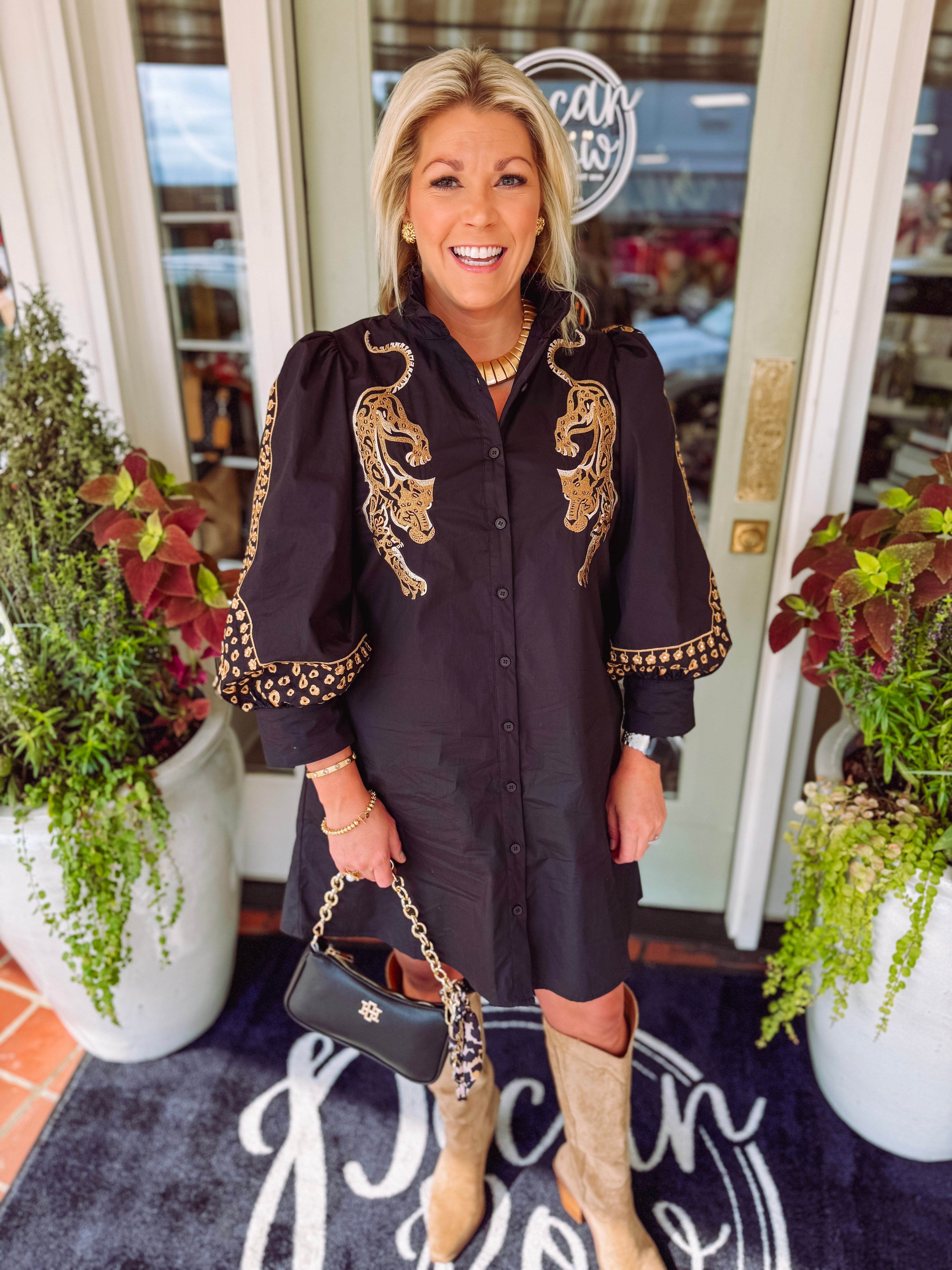 Black button down dress with gold detailing down the sleeves and leopards down each side.