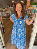 Blue and white floral dress with a button-front neckline and softly gathered waist.
