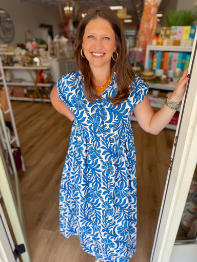 Blue and white floral dress with a button-front neckline and softly gathered waist.