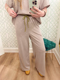  These easy knit pants feature a neutral cream and brown stripe with an olive contrast drawstring for the perfect little pop of fall color. 
