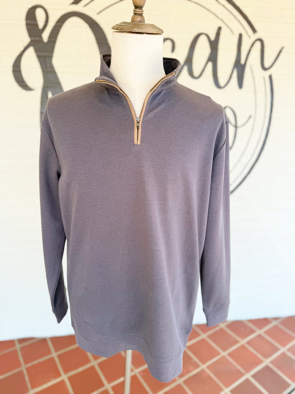  This lightweight quarter-zip pullover features a soft, smooth feel in a versatile neutral with a classic stand collar and tonal zipper detail. 