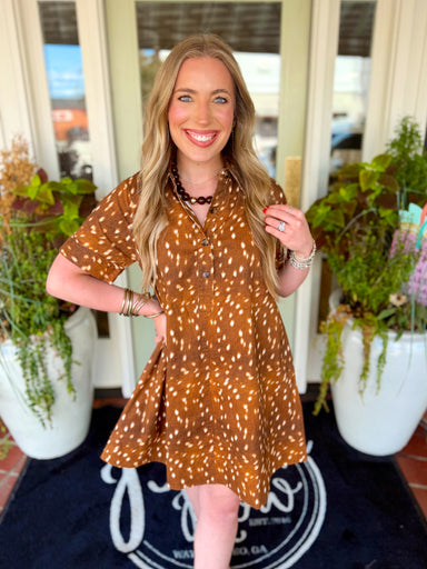 This animal print mini dress features a classic shirt collar, short cuffed sleeves and a button-down front for a polished touch.