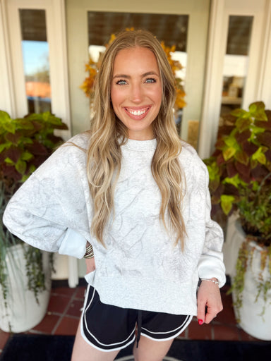 An easy light grey camo sweatshirt featuring a relaxed fit and cropped silhouette. 