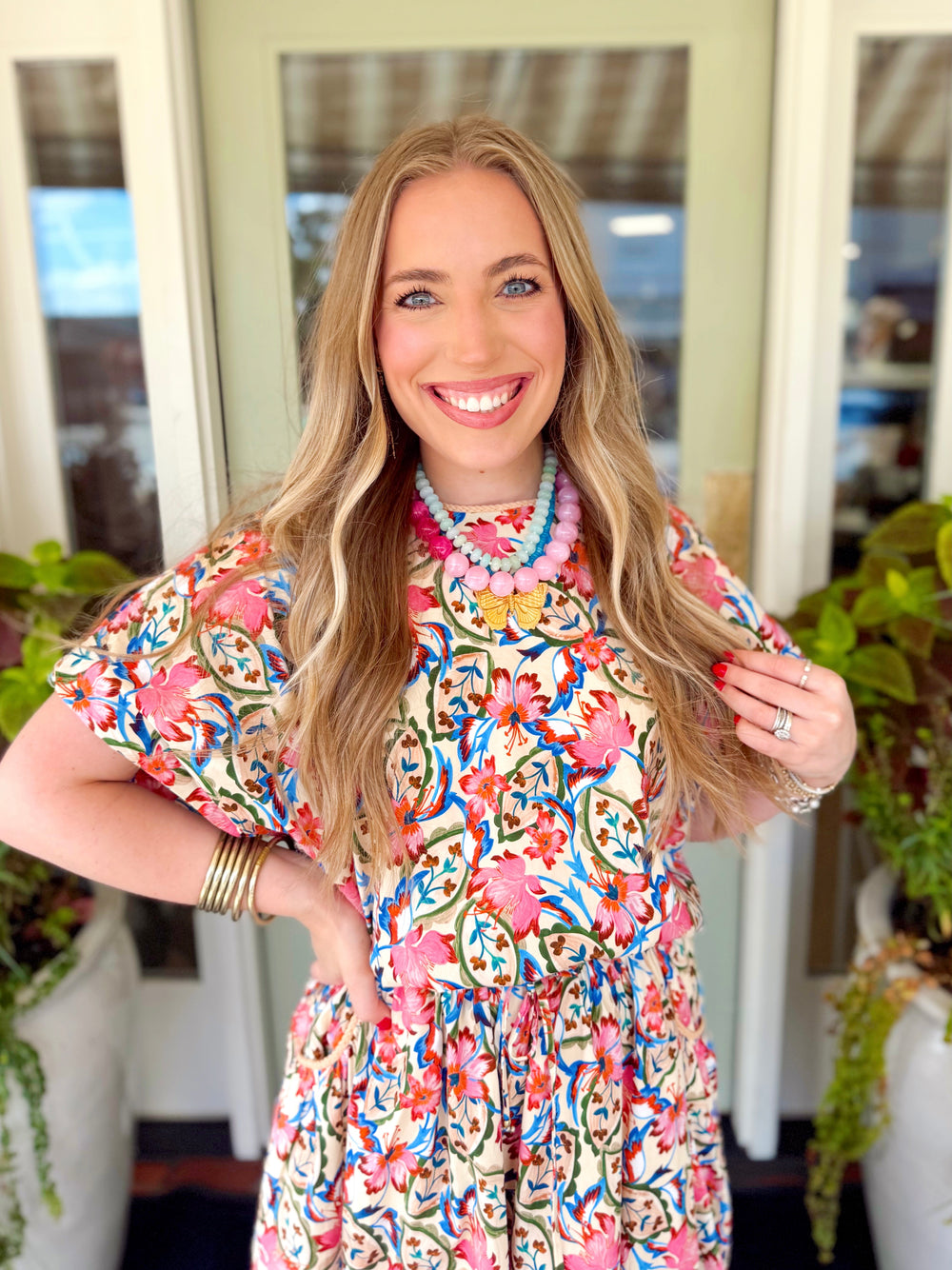 A colorful floral print bubble top with a subtle lace detail on the neckline
