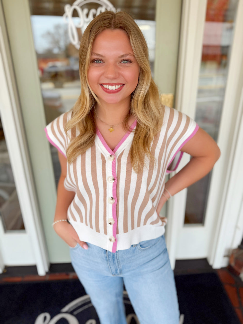 Striped v-neck sweater vest with pink detailing 