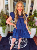 Navy blue dress with lace trim detailing on it