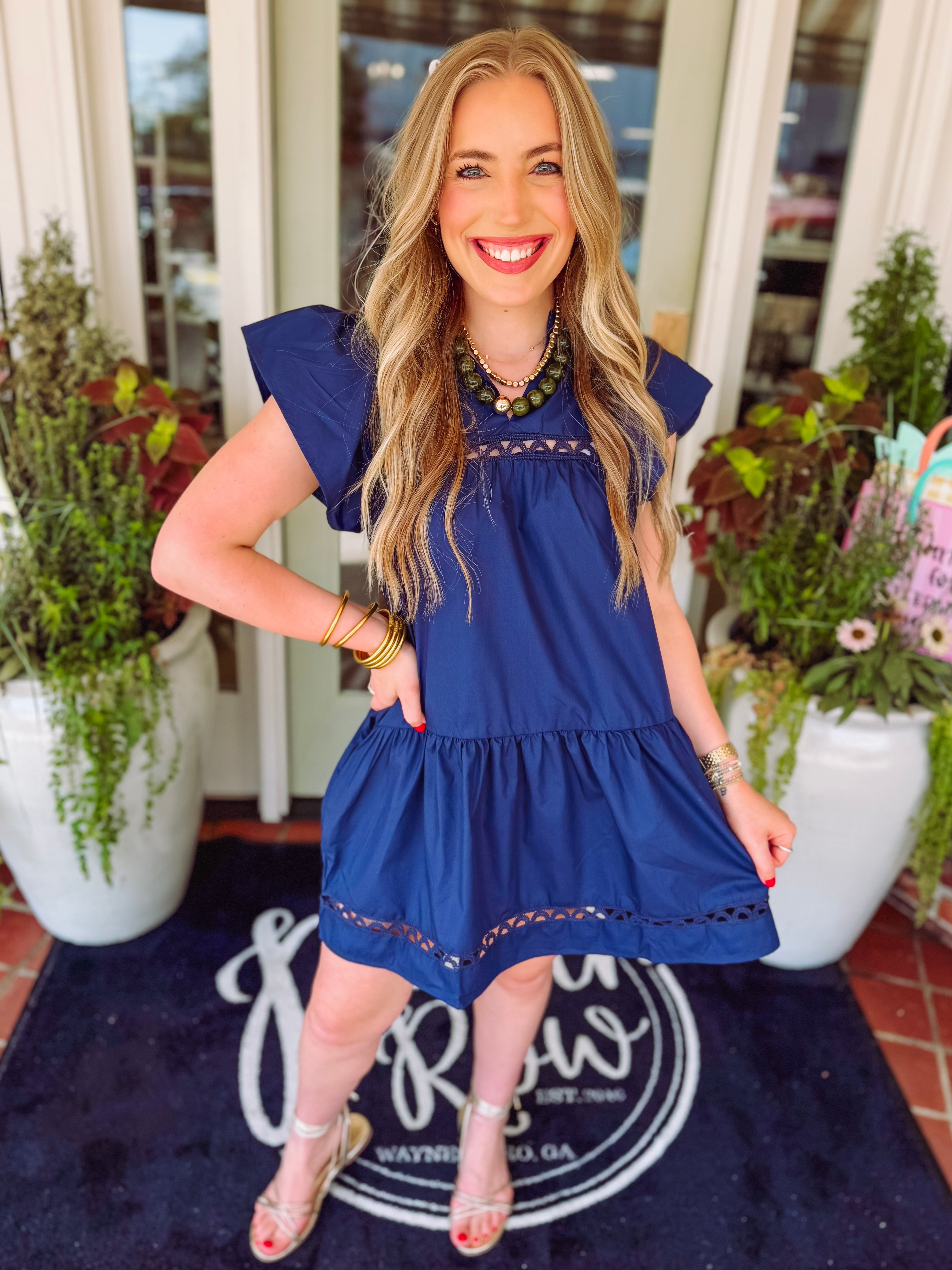 Navy blue dress with lace trim detailing on it