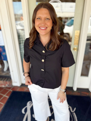 Solid black top with gold buttons on the front 