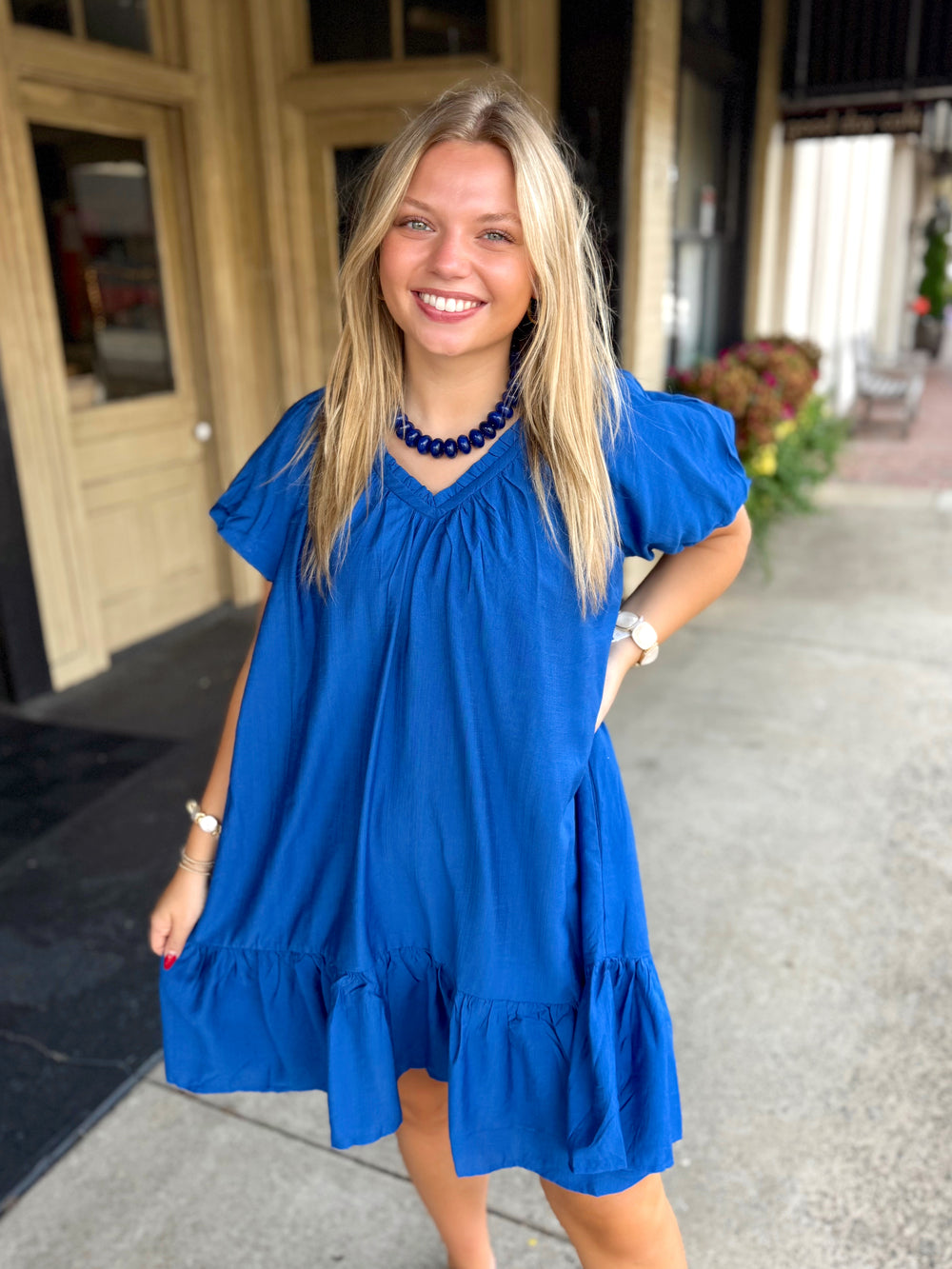 Bright royal blue short-sleeve dress with puff sleeves and a ruffled hem