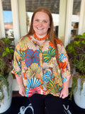  This tropical leaf print top features a vibrant mix of colors with a classic collared neckline and button-down front. 