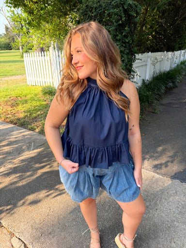 A navy blue halter top with a ruffle bottom