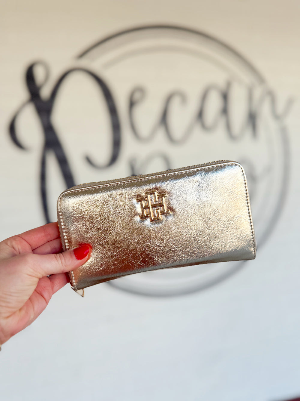 The wallet features an elongated zip design with a central zippered coin pouch and two sets of card holders for organized storage.