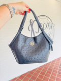 black textured saddle bag with long strap