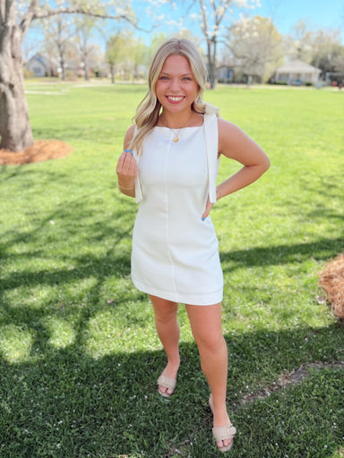 White dress with bow detailing on the straps 