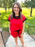 A red short-sleeve top with black trim.