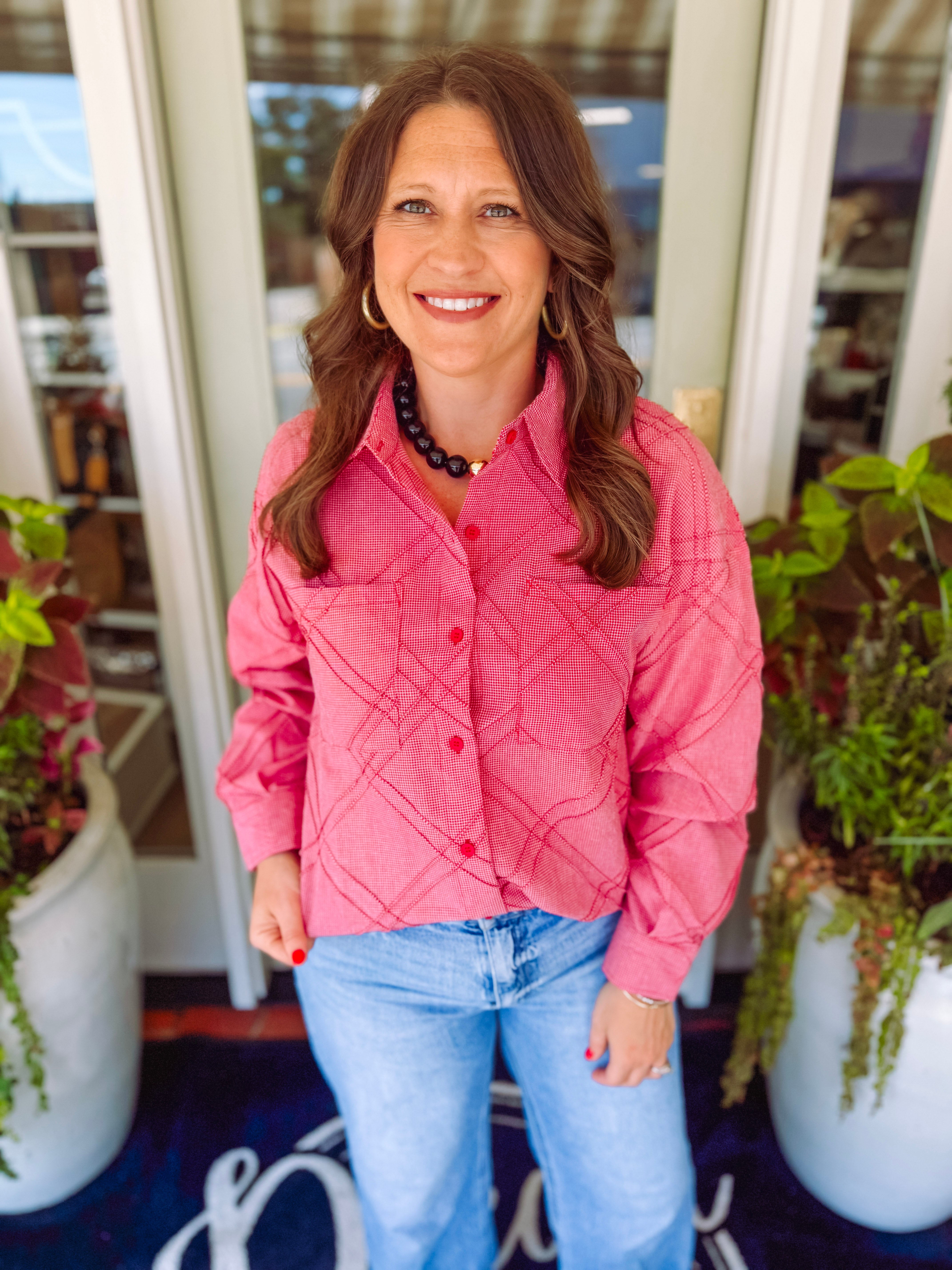 Red textured button down top with a subtle white pattern on it 