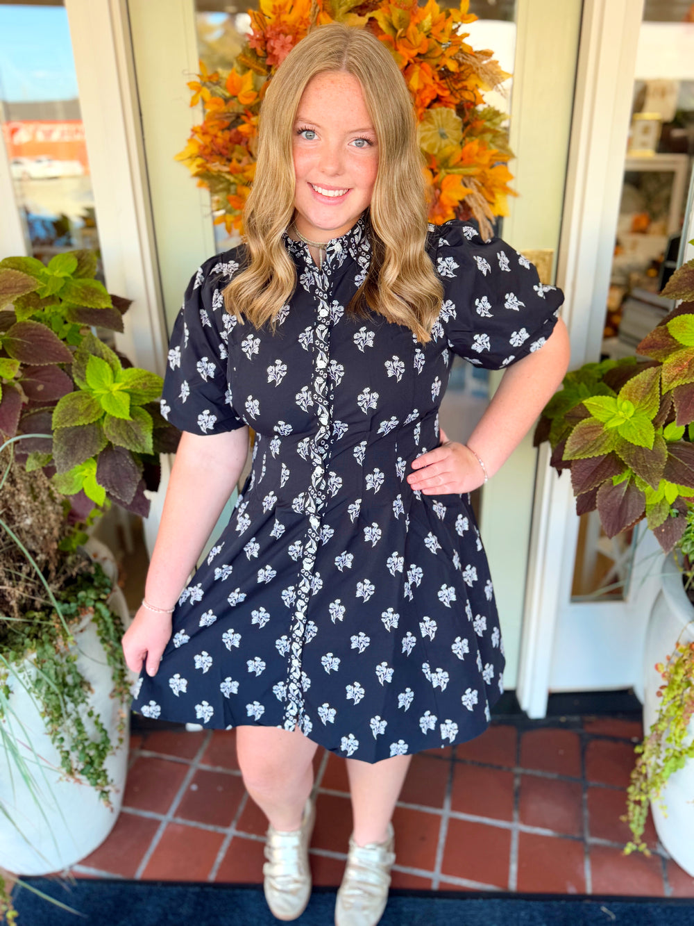 Featuring a classic point collar and bubble sleeves, it offers a flattering silhouette with just the right amount of volume.