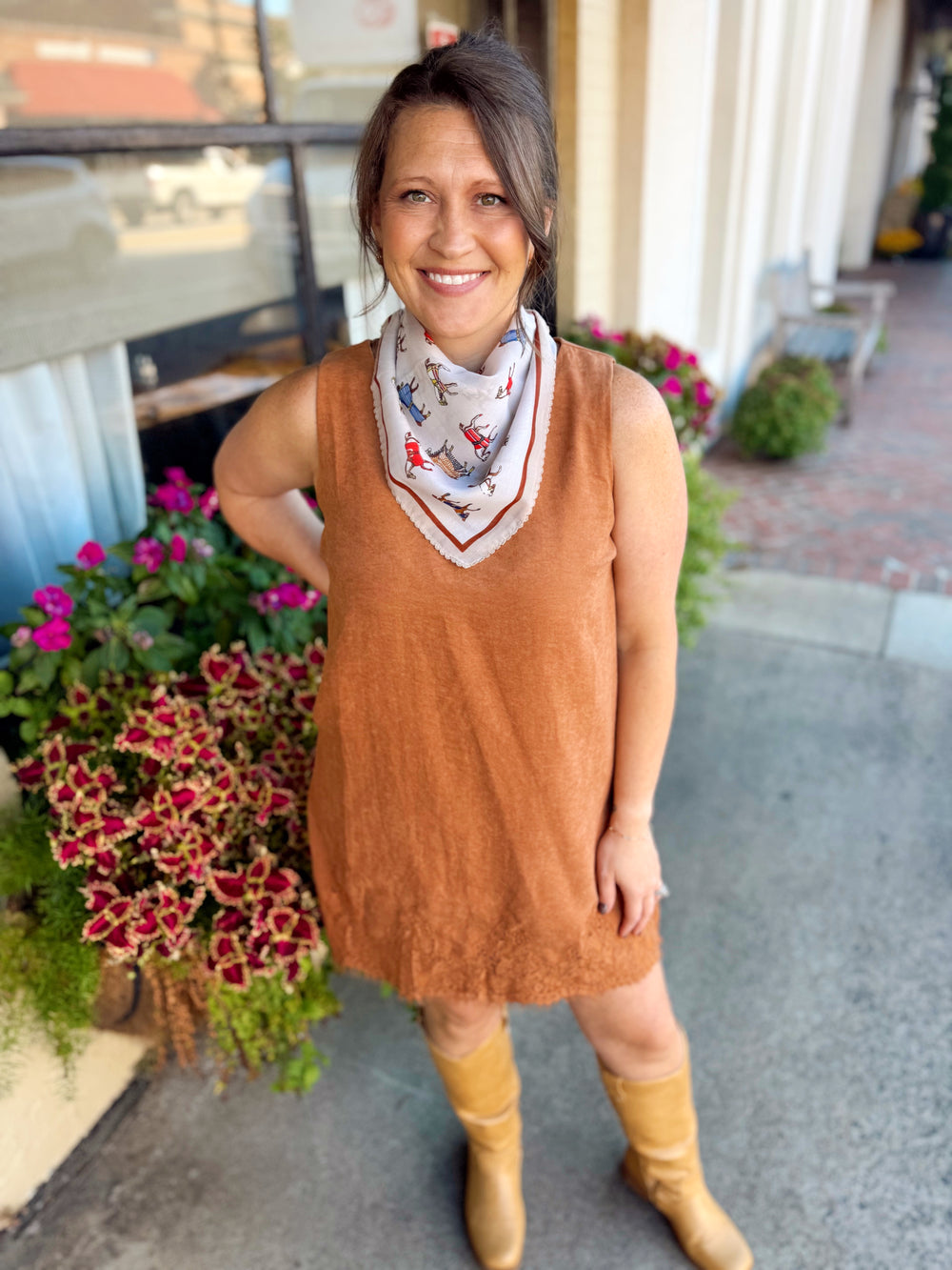 This sleeveless mini dress features a rich camel suede-look finish with delicate lace detailing for the prettiest contrast.