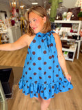 A polka dot tie neck sleeveless dress with a ruffle hem 