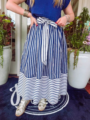 Navy and white striped skirt with a zipper on the side finish with an adjustable tie bow detailing on the front 
