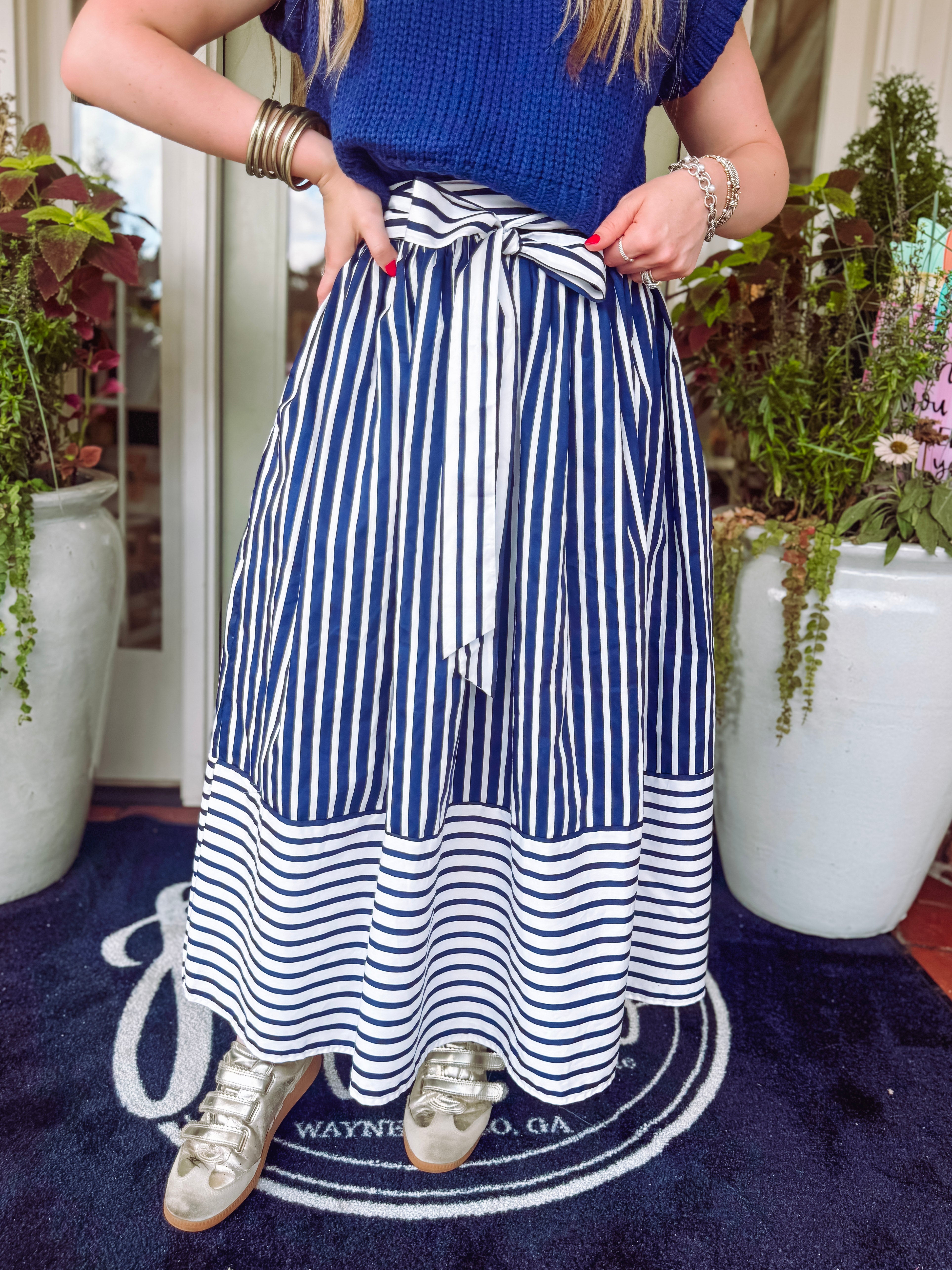 Navy and white striped skirt with a zipper on the side finish with an adjustable tie bow detailing on the front 