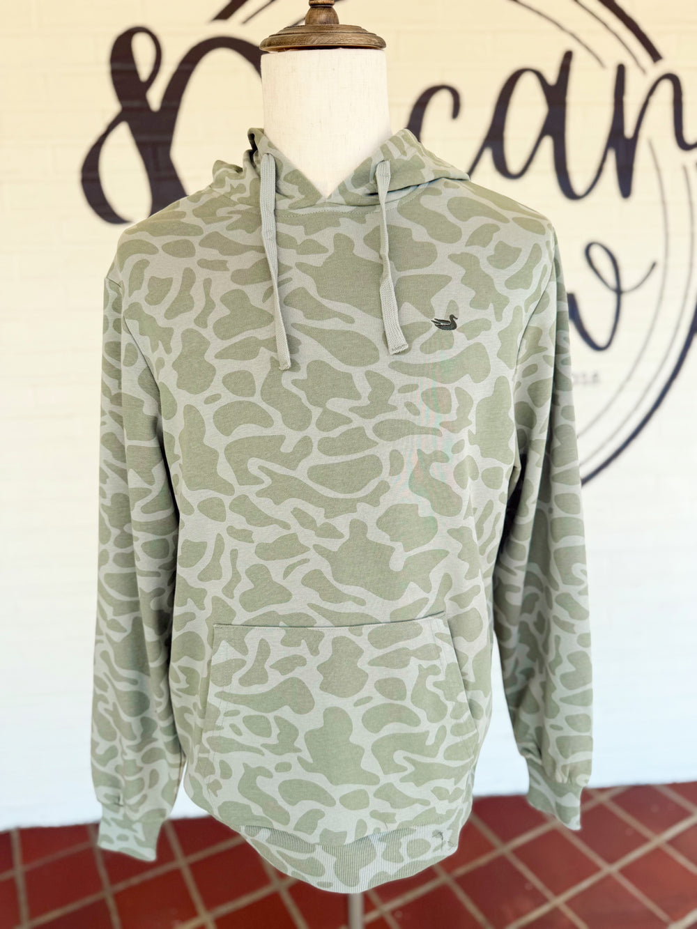 This lightweight camo hoodie features a soft tonal camouflage print in muted green hues, an adjustable drawstring hood, and a roomy front kangaroo pocket.