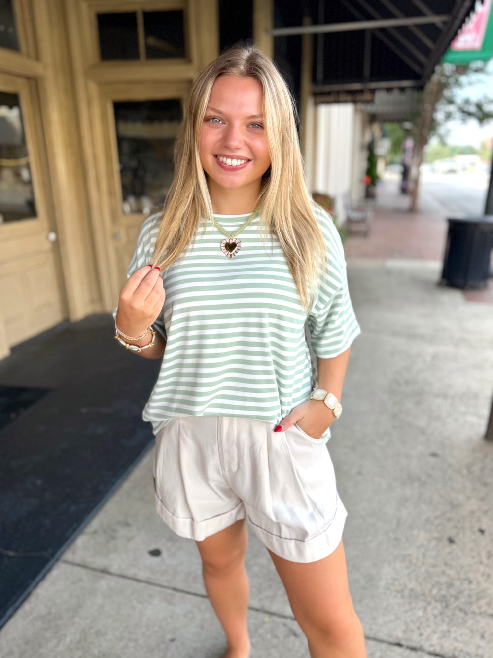 Light green and white striped short-sleeve t-shirt.