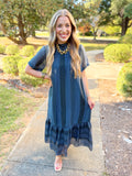 This dress features a beautiful mix of prints throughout with a high neckline and an easy, flowing silhouette.