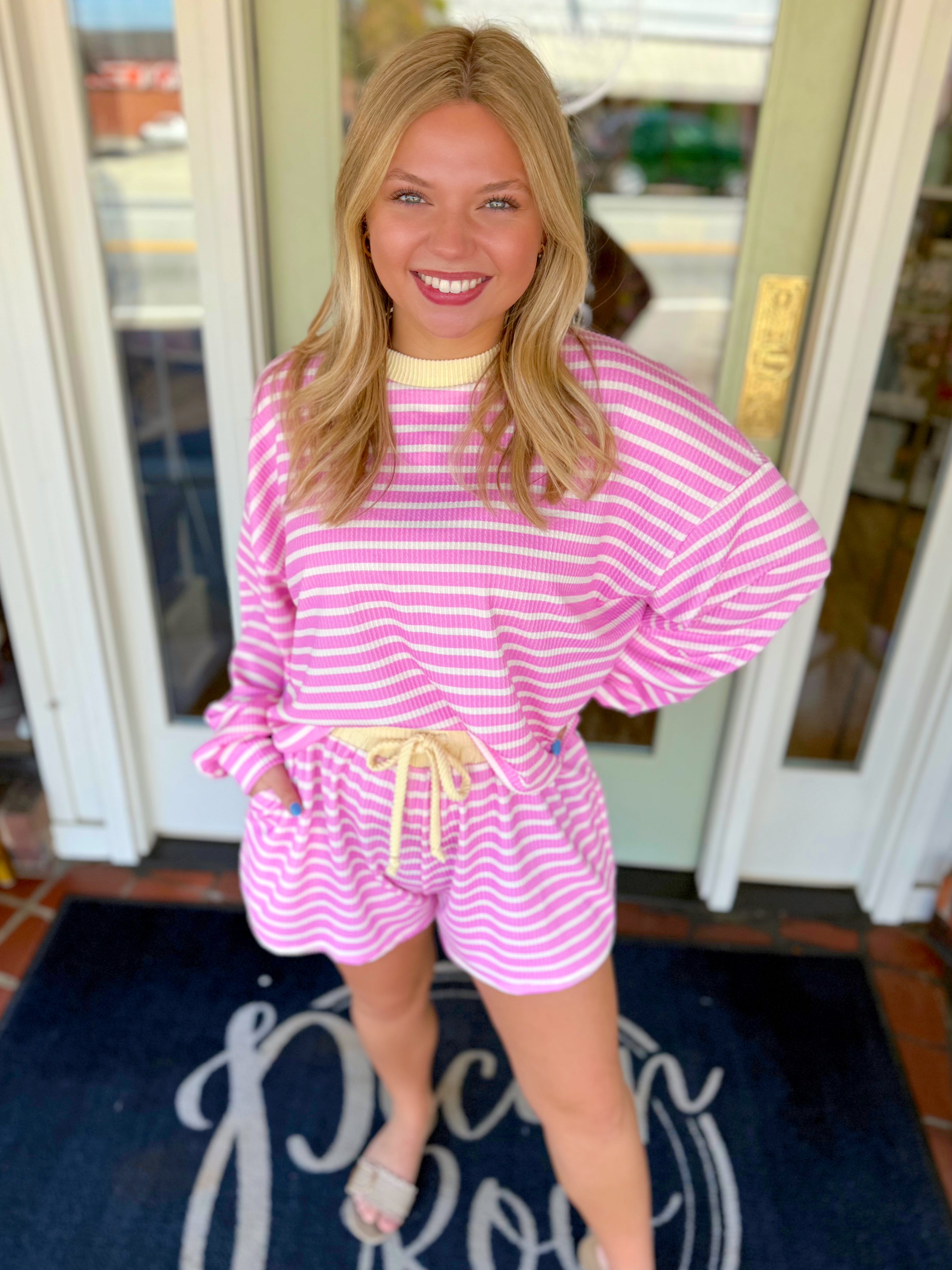 Pink and white striped textured top with yellow trim detailing 