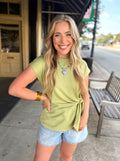 Light olive green short-sleeve top with a side tie detail.