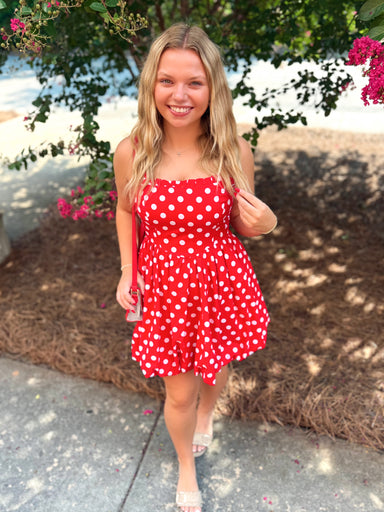 A red spaghetti strap dress with white polka dots