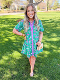 Green button down dress with pink florals on it 