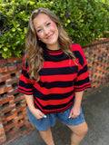A red and black horizontally striped knit mock neck top