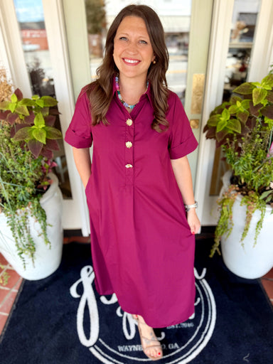 Solid short sleeve midi dress featuring a shirt collar and snap button closure at front.
