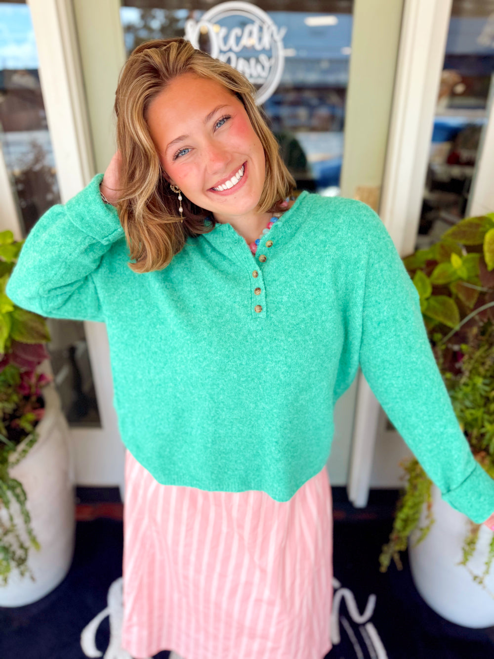 A pretty green henley sweater that features a soft knit texture with a relaxed silhouette and a button-front neckline for a classic touch.