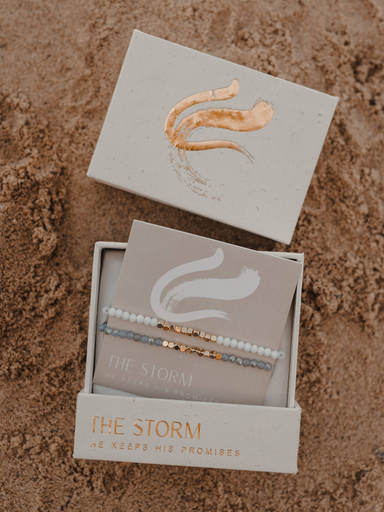 Bracelets in a box with 'The Storm' branding on a textured surface