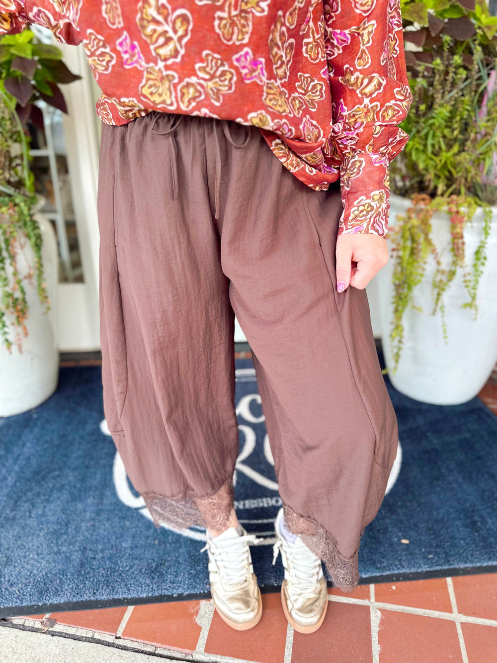 A fun pair of cropped balloon pants featuring a relaxed, easy silhouette with delicate lace trim detailing for a feminine touch.