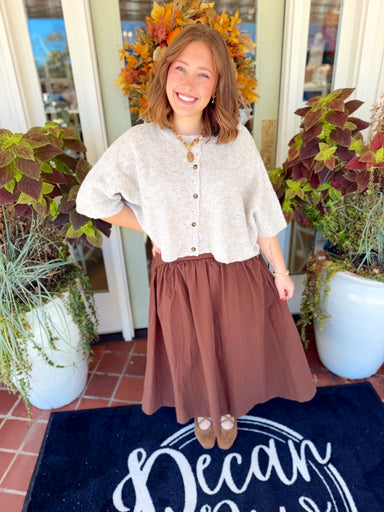 This cardigan sweater top features a textured knit design with button detailing down the front and a comfortable, relaxed silhouette.