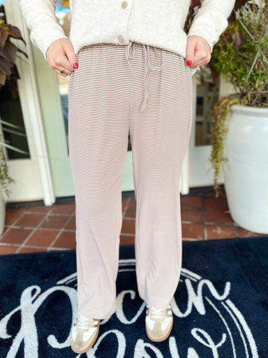 These pants feature an easy neutral micro-stripe with a relaxed wide-leg silhouette and adjustable drawstring waist.