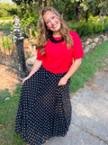 A red short-sleeve button up knit top.