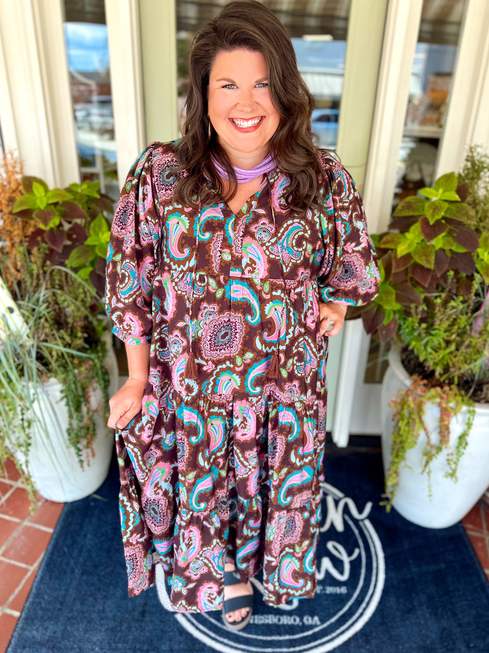 This printed dress features a chocolate brown base covered in a colorful paisley-inspired print, giving it the perfect mix of boho and feminine style.