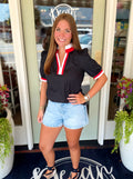 A black short-sleeve blouse with red and white trim by Mary Square