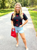 A black short-sleeve shirt with a red 'G' monogram pattern all over by Stewart Simmons