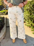  These cream pants feature an allover mallard duck print in soft, earthy colors with a flattering high-rise fit and wide-leg silhouette. 