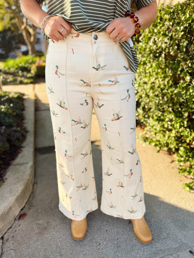  These cream pants feature an allover mallard duck print in soft, earthy colors with a flattering high-rise fit and wide-leg silhouette. 
